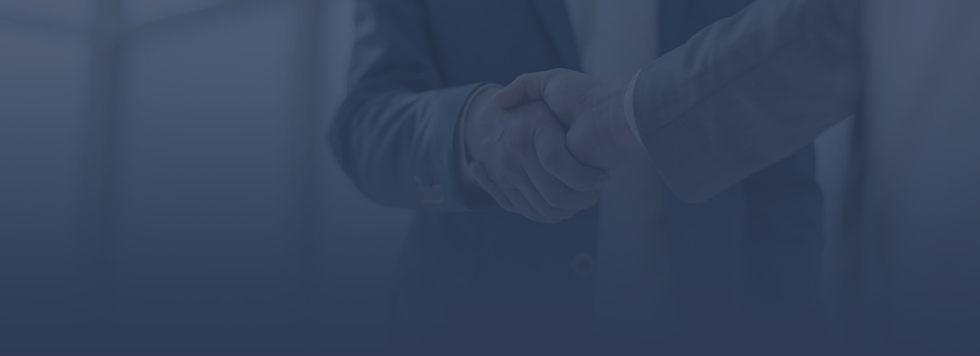 Two men in suits shaking hands